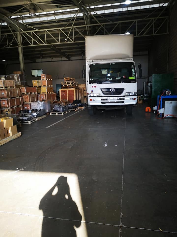 Curth Movers UD truck parked inside a warehouse