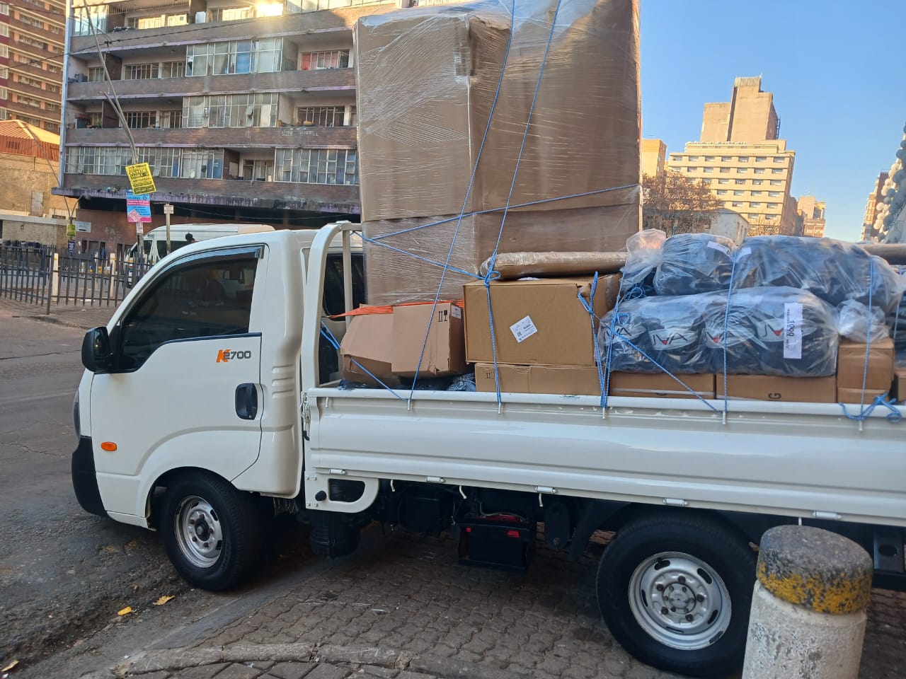 Loaded Curth Movers bakkie with boxes strapped down